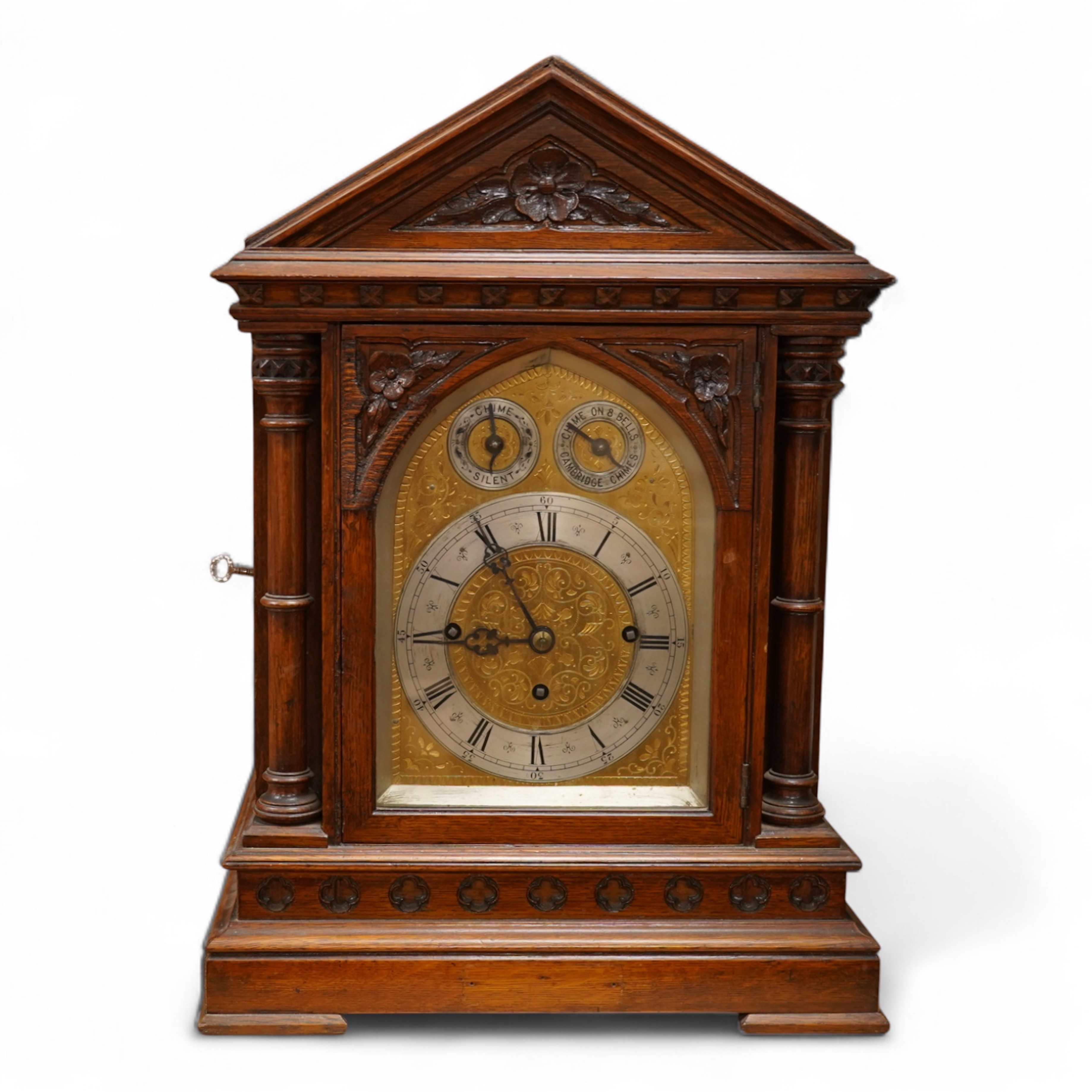 A German Gothic style oak mantel clock, early 20th century, with pendulum and keys, 49cm high